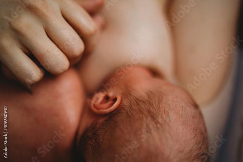 Close up of baby breastfeeding showing lots of skin photo