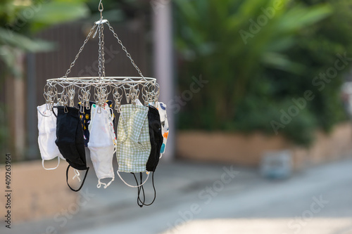 Wash the face mask and dry in the air. Handmade own masks to protect from dust pollution and virus epidemics such as covid-19. Cotton cloth mask hanging outdoor after the used and washing. 