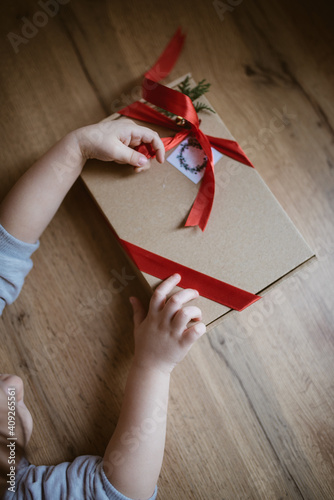 Little girl opens presents at a table. photo