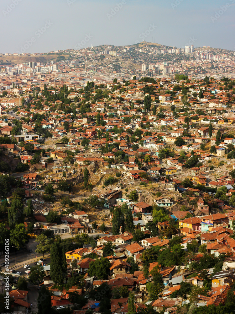 Cityscape from hills of Ankara Old Town, Turkey. Remote view of slums, gecekondu, in the old neighborhood of Ankara and new buildings rising behind. Urban transformation. Selective focus.