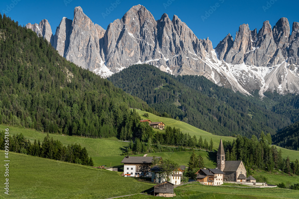 Santa Magdalena, Dolomites UNESCO, village with two iconic churches located between mountains and meadows 