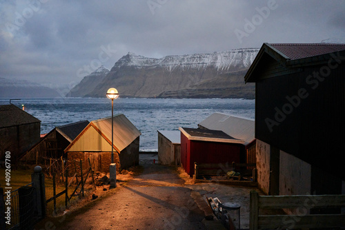 Funningur village at night with ocean and mountains in distance