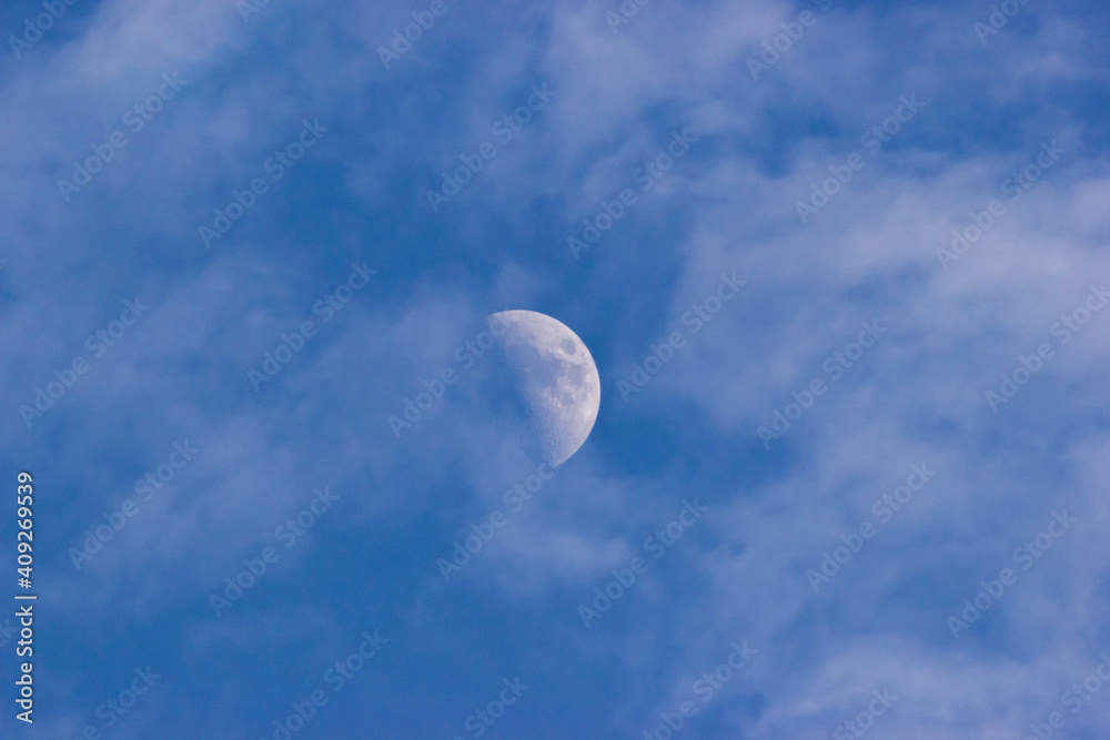 Moon on a blue sky and white clouds Moon on a blue sky and white clouds
