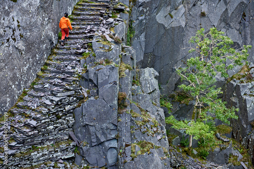 woman hiking up stairs at Slate quarry in North Wales