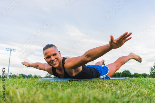 Athletic man performing yoga while working out photo