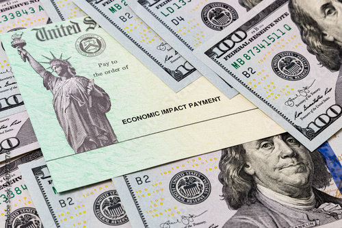 фотографія Economic impact stimulus treasury check and 100 dollar bills