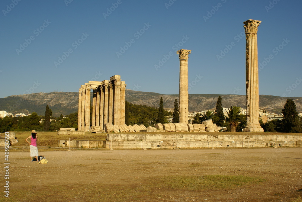A tourist photographing the ruins of the Temple of Zeus (Olympiaion) in Athens, Greece
