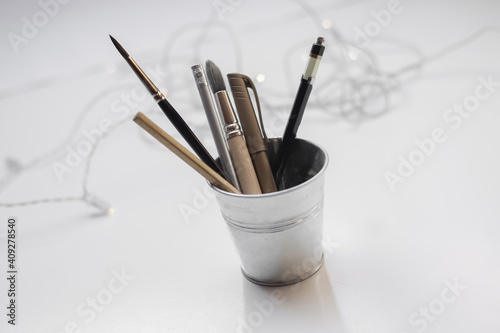 Set of creative art drawings tools for lettering, watercolor painting or sketching - pencils, brushes and markers in steel holder 