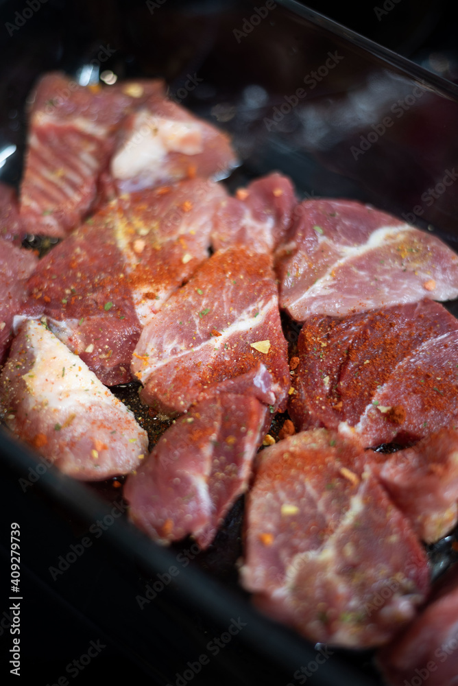 Raw meat covered with cooking spice