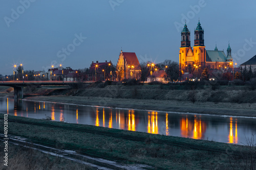 Poznan Cathedral with reflection in Warta River at night, Poznan, Poland