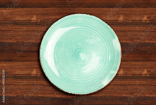 Empty ceramic blue plate on wood table