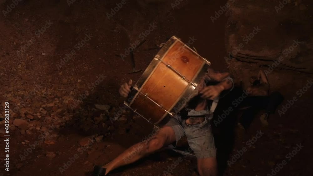 Funny drummer plays the bass barrel. Crazy guy beats the folk drum. Funny drummer plays the bass barrel. Crazy guy beats the folk drum.