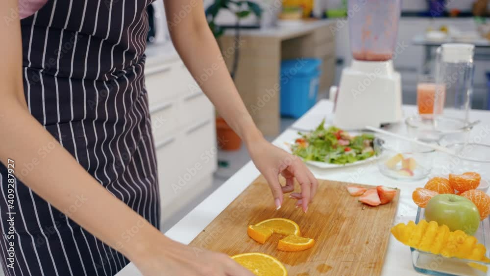 Portrait Asian young happy beautiful Woman eating spoon of fruit smoothie in the kitchen. female emotion making a very sour expression. Healthy lifestyle concept. Portrait Asian young happy beautiful Woman eating spoon of fruit smoothie in the kitchen. female emotion making a very sour expression. Healthy lifestyle concept.