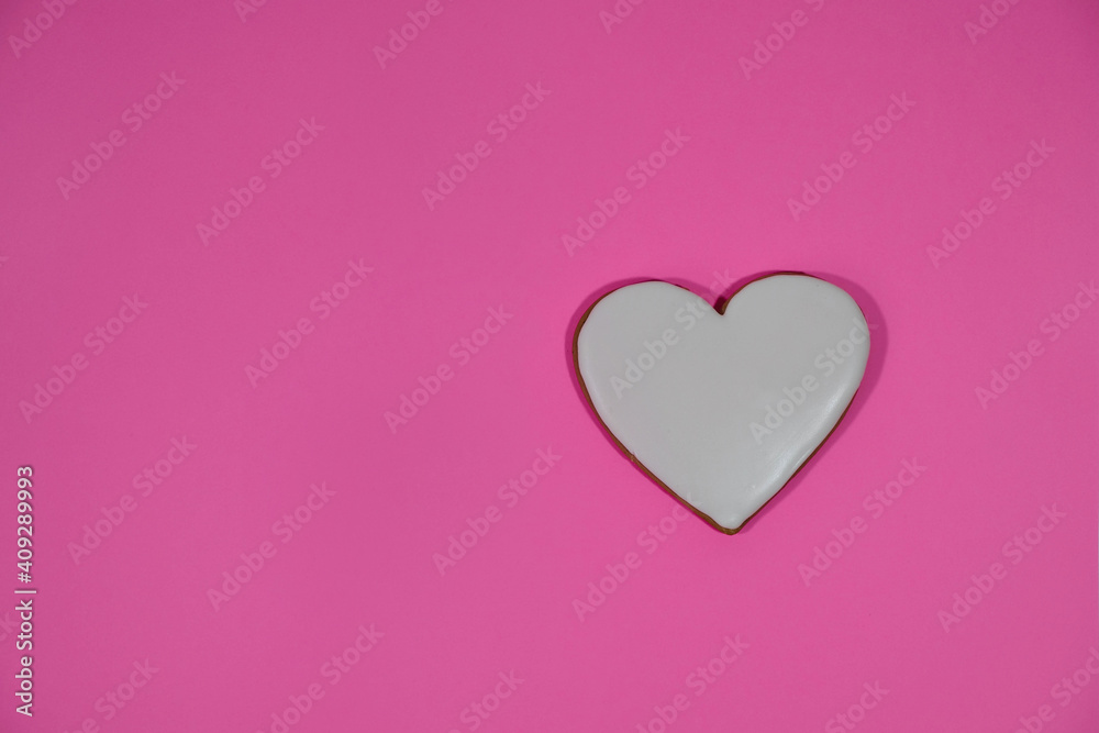 Festive gingerbread in a heart shape on pink background. Valentine's day. Mockup.  Minimalism. Copy space. Top view. 