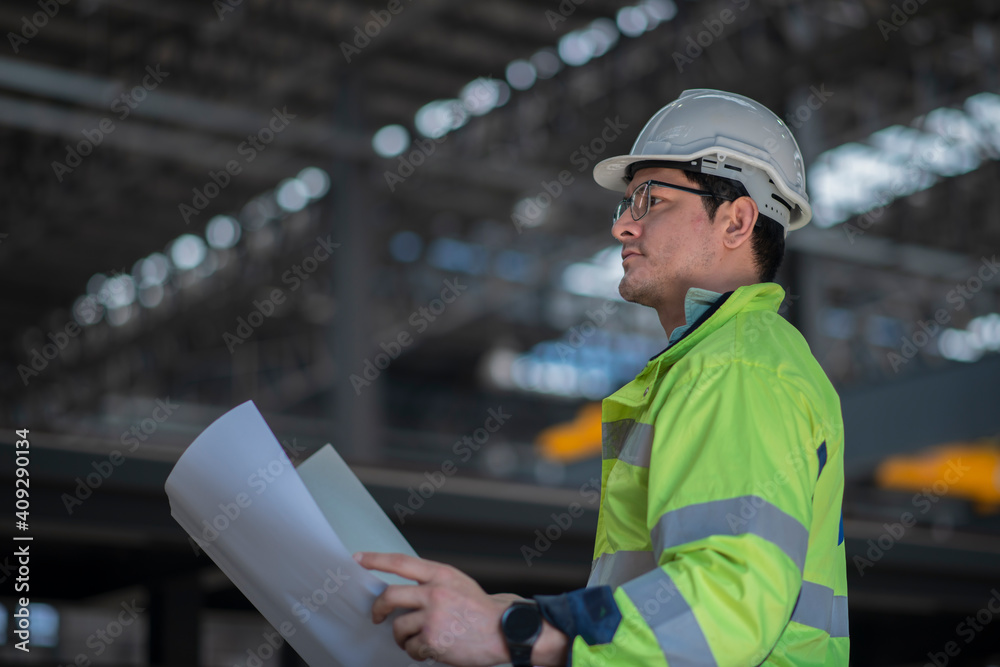 worker work on factory with hand hold drawing. Heavy Industry Engineer in Pipe Manufacturing Factory, checking job with drawing. worker work on factory with hand hold drawing. Heavy Industry Engineer in Pipe Manufacturing Factory, checking job with drawing.