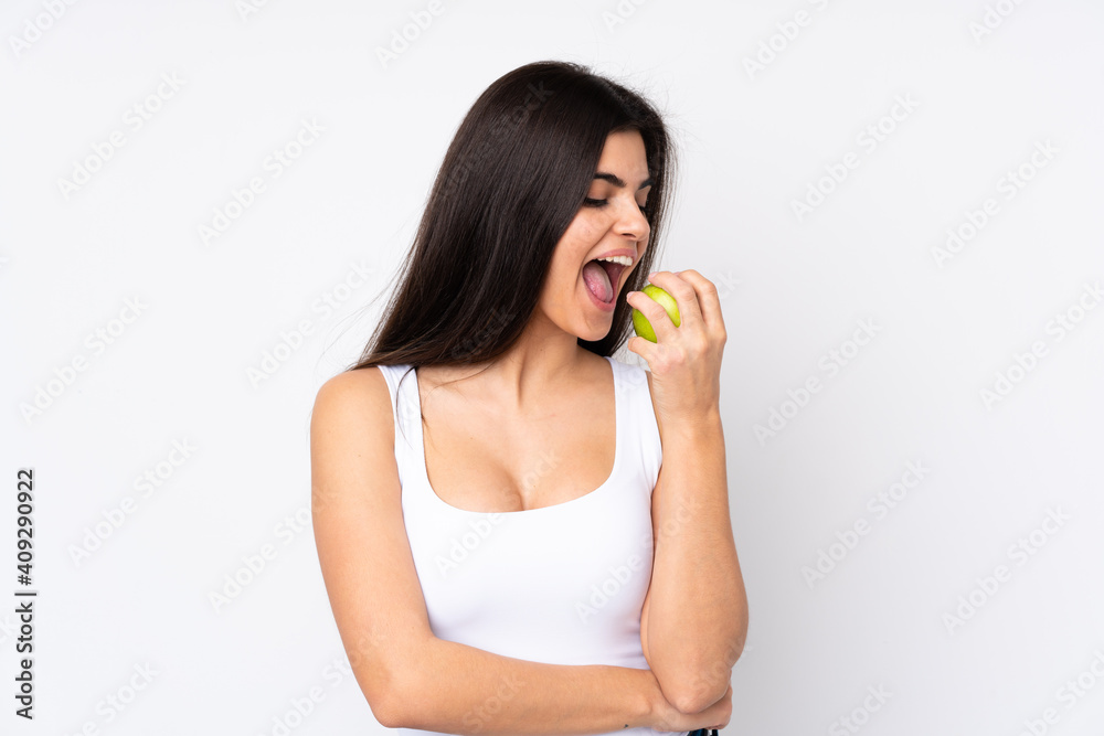 Young woman over isolated white background eating an apple Young woman over isolated white background eating an apple