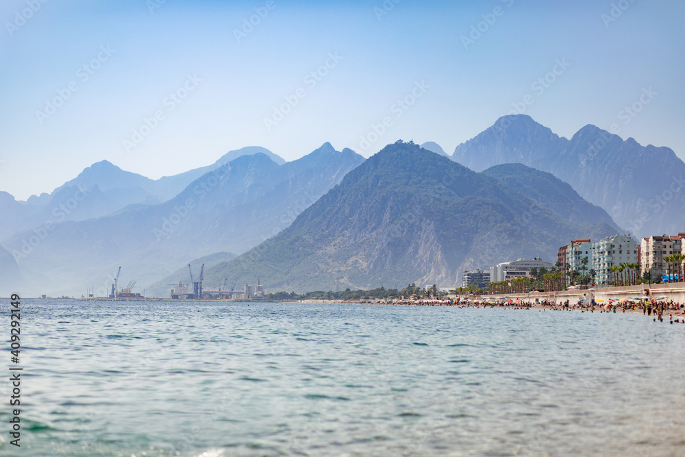 Naklejka premium Coast strewn with holidaymakers in the off-season, Konyaalti district, Liman. Antalya, Turkey - October 25, 2020.