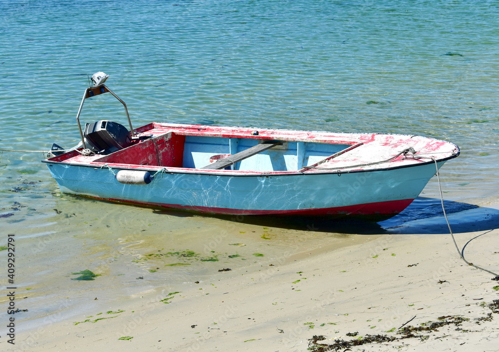 Old wooden motor boat moored on a beach. Rias Baixas Region, Galicia, Spain.