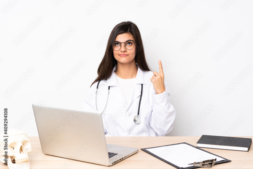 Professional traumatologist in workplace pointing with the index finger a great idea Professional traumatologist in workplace pointing with the index finger a great idea