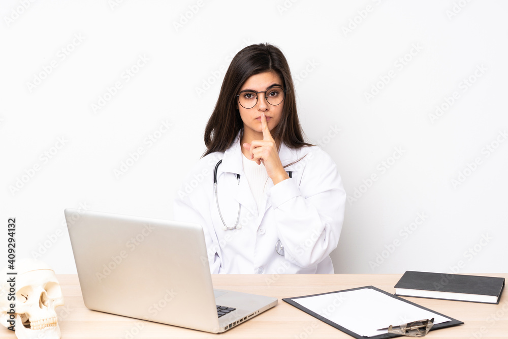 Professional traumatologist in workplace doing silence gesture Professional traumatologist in workplace doing silence gesture
