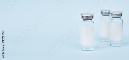 Vaccine three jars, drugs mockup. on a blue background. copy space, banner