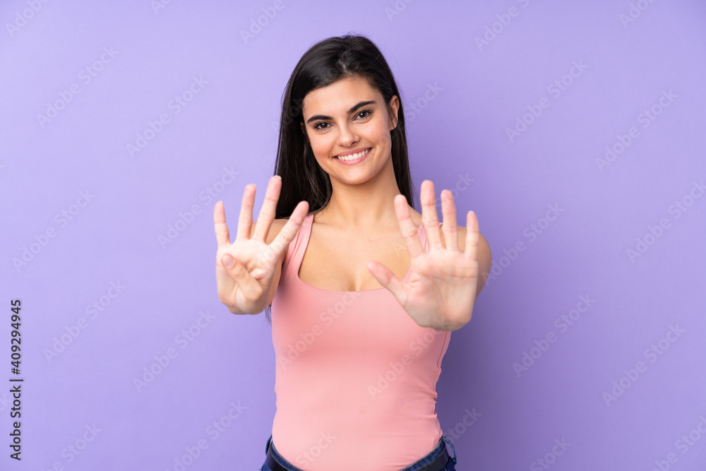 Young woman over isolated purple background counting nine with fingers