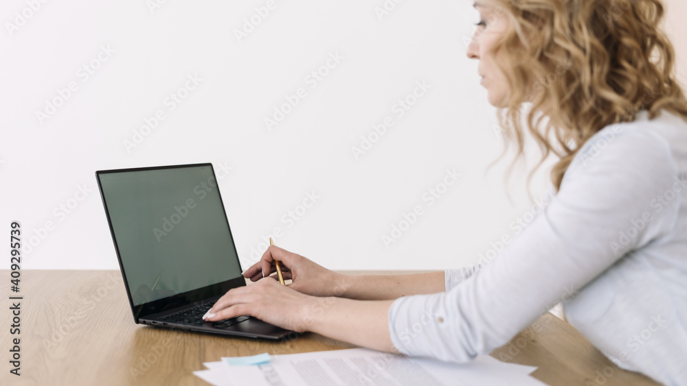 Concentrated business woman using laptop computer in office Concentrated business woman using laptop computer in office