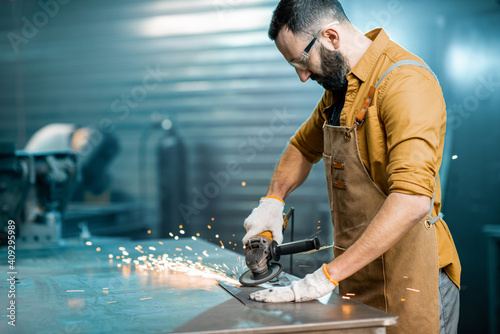 Man working with metal at the workshop photo