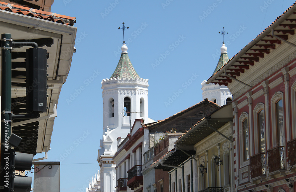 Colonial buildings in Cuenca with the bell tower of a church in the background, Ecuador 
