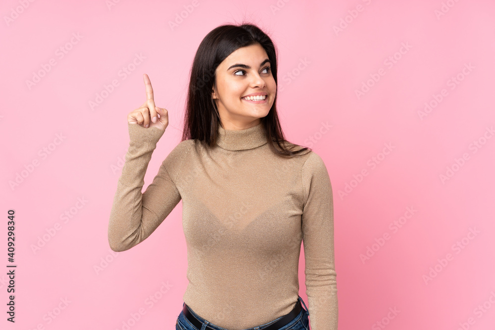Young woman over isolated pink background intending to realizes the solution while lifting a finger up Young woman over isolated pink background intending to realizes the solution while lifting a finger up