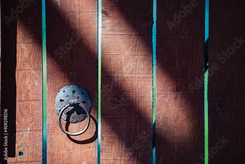 Detail of wooden door with metal handle photo