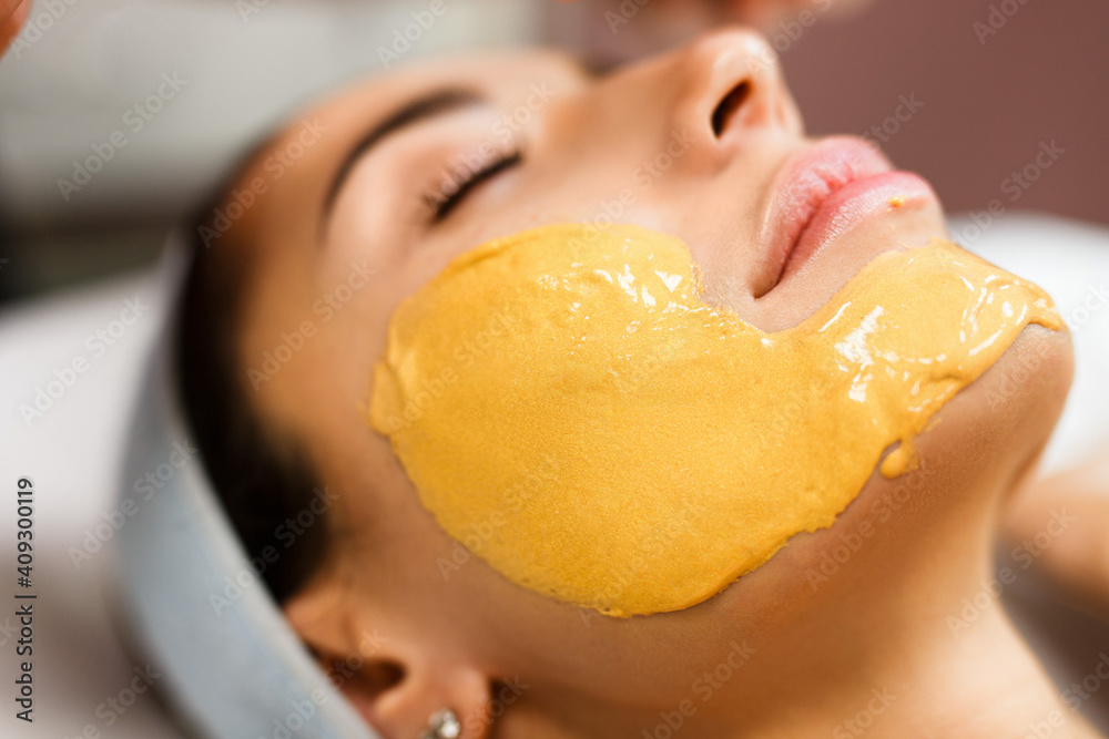 Procedure for skin care. Doctor in cosmetology office applies an yellow