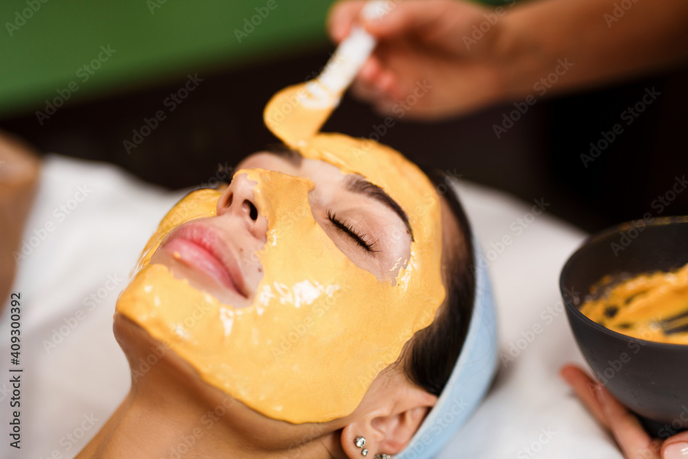 Procedure for skin care. Doctor in cosmetology office applies an yellow