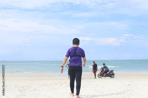 a man confidently walk to the sea