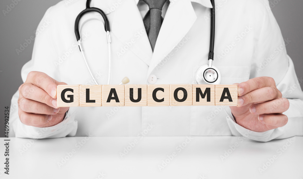 Doctor holds wooden cubes in his hands with text GLAUCOMA Doctor holds wooden cubes in his hands with text GLAUCOMA