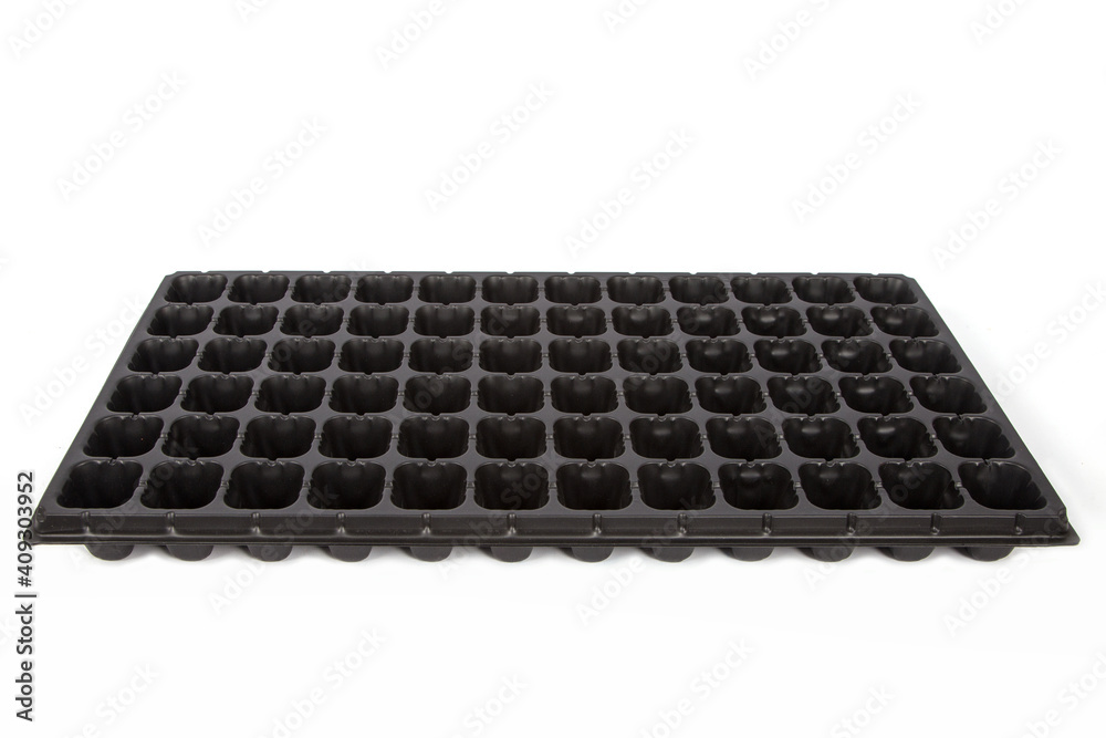 Naklejka premium Black cassette for seedlings on a white background.