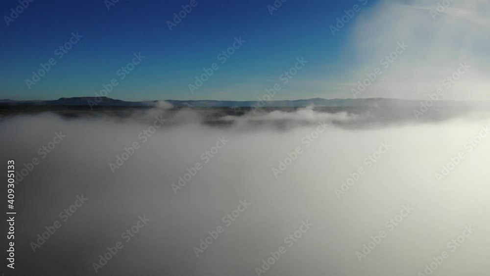 Rise up through cloud bank to move forward toward hills and mountains Rise up through cloud bank to move forward toward hills and mountains