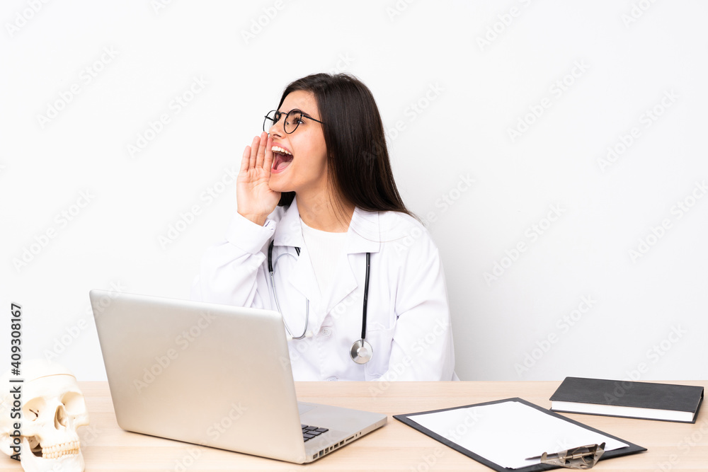Professional traumatologist in workplace shouting with mouth wide open Professional traumatologist in workplace shouting with mouth wide open
