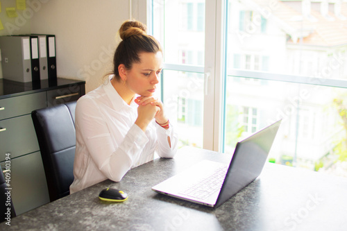 Office worker girl thinks over the project