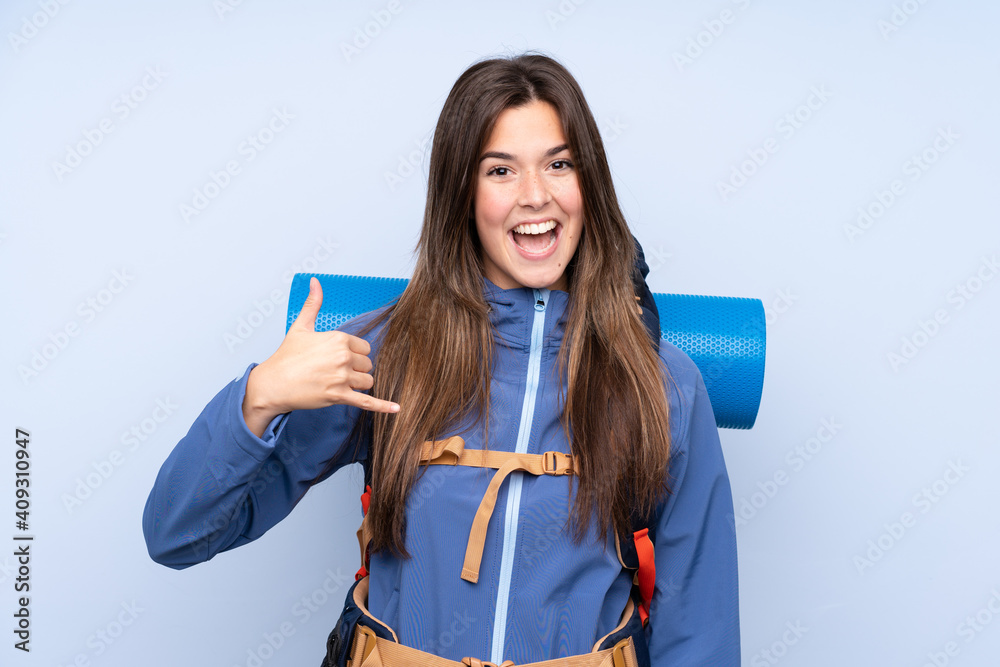 Teenager hiker girl over isolated background making phone gesture Teenager hiker girl over isolated background making phone gesture