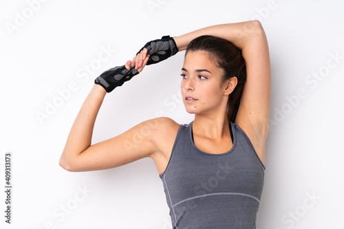 Teenager Brazilian sport girl over isolated white background stretching © luismolinero