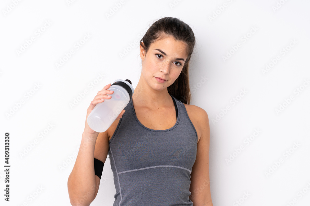 Teenager Brazilian sport girl over isolated white background with sports water bottle Teenager Brazilian sport girl over isolated white background with sports water bottle