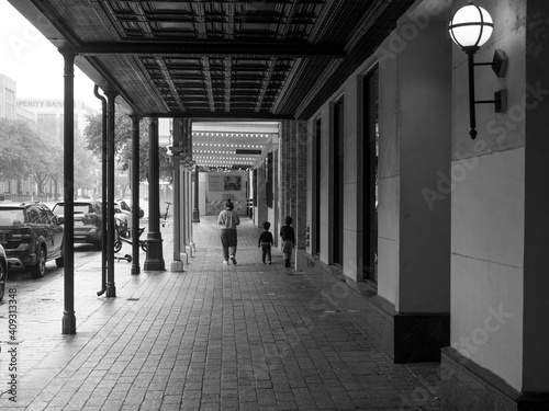 Young woman and two children on Austin sidewalk