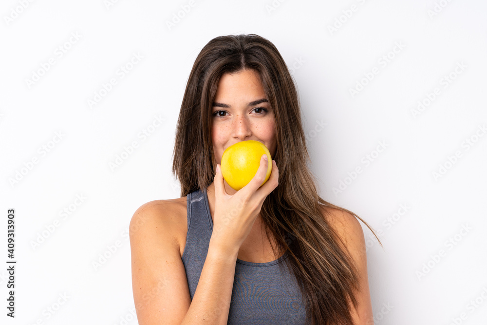Teenager Brazilian girl with an apple over isolated background Teenager Brazilian girl with an apple over isolated background