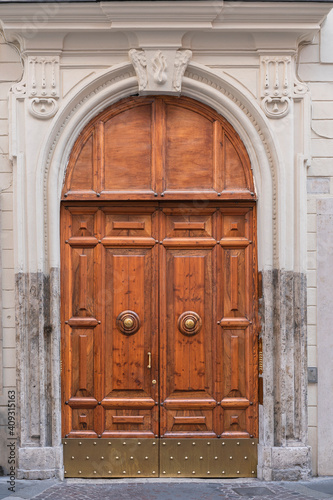 wooden door with a beautiful decorative finish in the historical part of Rome