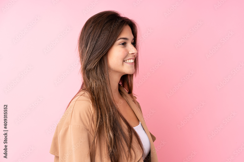 Teenager Brazilian girl over isolated pink background looking to the side - obrazy, fototapety, plakaty 