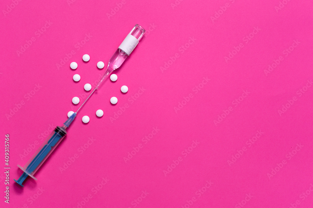 A heart made of white pills was pierced with a syringe and ampoule. Pink background. Photo horizontal with place for text. A heart made of white pills was pierced with a syringe and ampoule. Pink background. Photo horizontal with place for text.