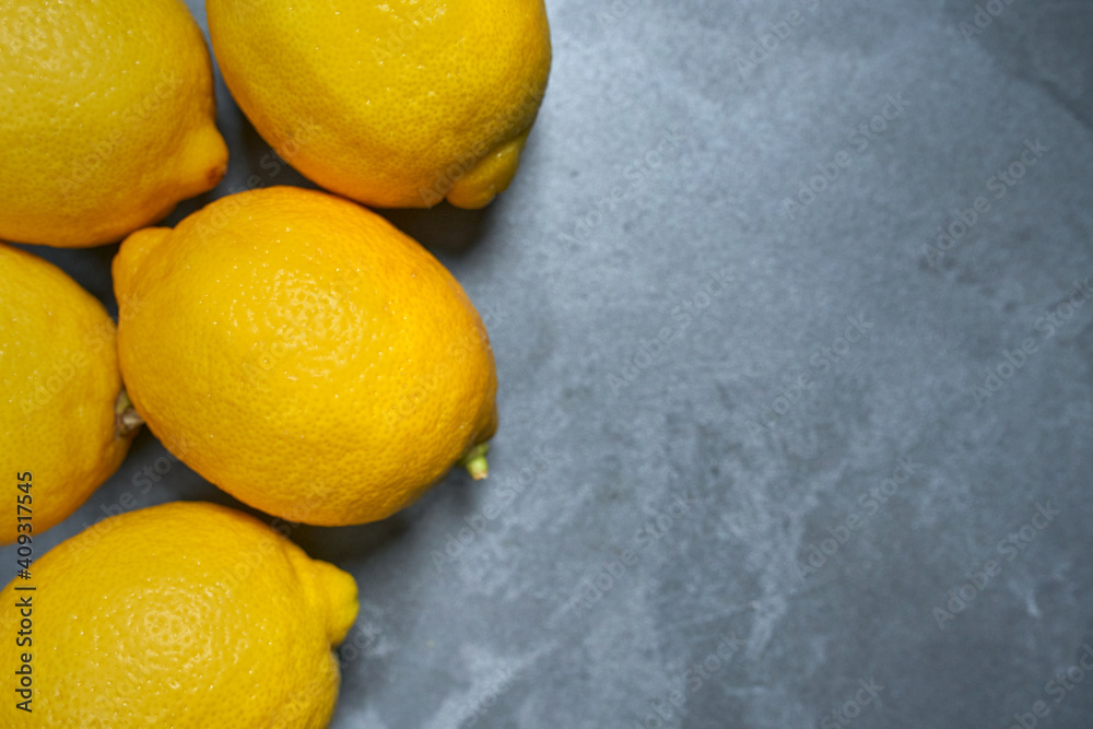 Whole lemons with skin on gray stucco background. CITRUS CITRIC Whole lemons with skin on gray stucco background. CITRUS CITRIC