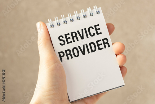 Closeup on business woman hand holding a card with SERVICE PROVIDER message, business concept image with white background