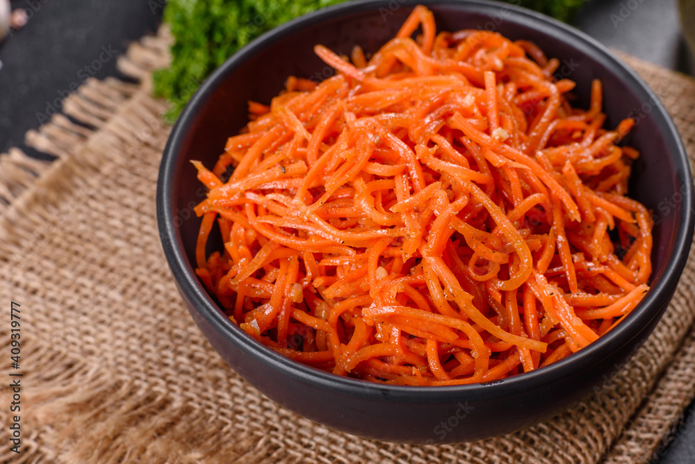 Delicious spicy juicy bright Korean carrots in ceramic dishes Delicious spicy juicy bright Korean carrots in ceramic dishes